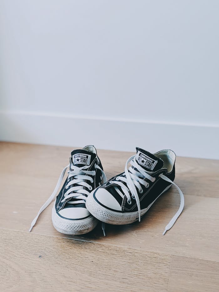 digital Two classic black sneakers with white shoelaces, perfect for casual style.